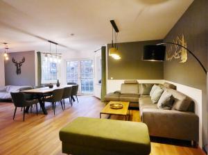 a living room with a couch and a table at First Class Domizil Großer Bergzauber inklusive MeineCardPlus in Willingen
