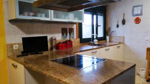 a kitchen with a counter top with a sink at CASA IRIANA - Chimenea I Jardín I Barbacoa in Ourense