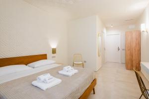 Postel nebo postele na pokoji v ubytování Porta D'Oro Charming House II & Spa