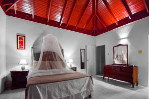 a bedroom with a bed with a veil on it at Harriott Heights in Mandeville