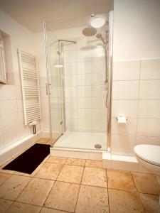 a bathroom with a shower and a toilet at stayinhostel in Hamburg