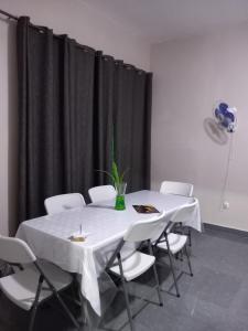 Pensao do Viajante في شيمويو: غرفة طعام مع طاولة وكراسي بيضاء