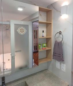 a bathroom with a shower and a glass shower backdoor at Angi Hosting in Porto Alegre