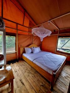 a bedroom with a bed in a tent at Mzinga Retreat in Gitesi