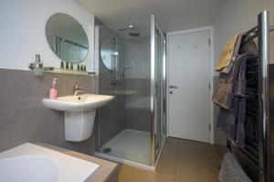 a bathroom with a shower and a sink and a mirror at Entire Apartment in Central Brockenhurst in Brockenhurst