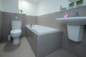 a bathroom with a toilet and a sink at Entire Apartment in Central Brockenhurst in Brockenhurst