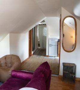 Cozy Tiny Haus Apt في Torrington: غرفة معيشة مع أريكة ومرآة