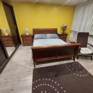 a bedroom with a bed and a yellow wall at Sunstreet in Lubin