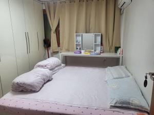 two beds in a room with a desk and a mirror at Lion's home 외국인 전용 in Seoul