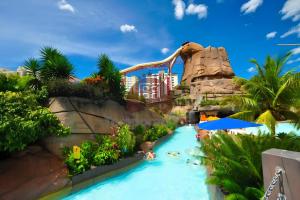 a water slide at a resort with people in it at Piazza diRoma com acesso ao Acqua Park - Temporada CN in Caldas Novas