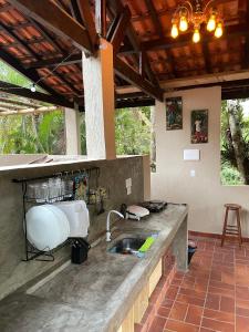 a kitchen with a sink and a counter top at Vila Guaraú in Peruíbe