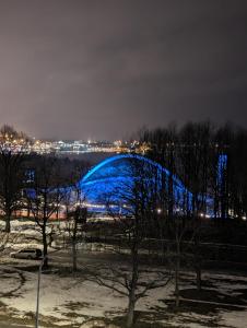 a blue bridge is lit up at night at Comfortable apartament to stay in Tallinn in Tallinn