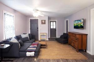 a living room with a couch and a table at Cozy Modern Farmhouse 2 Bedroom Apartment in Torrington