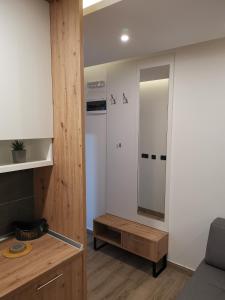 a living room with a table and a mirror at Harmony, Residence Hill A85 in Kopaonik