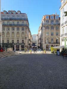 a city square with buildings and a cobblestone street at Lumineux appartement in Louvain-la-Neuve