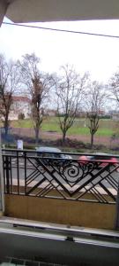 a view of a fence with trees in the background at Coquet 2 pièces proche de Paris in Bagnolet +9 photos