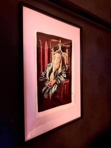 a painting of a pope in a frame on a wall at The Wizards House York - discounts for long stays in York