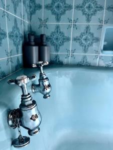 a bathroom sink with a silver faucet at The Wizards House York - discounts for long stays in York