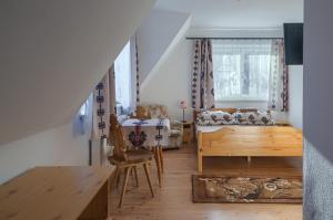 sala de estar con cama y mesa en una habitación en Willa Skorusa, en Zakopane