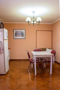 a kitchen with a table and chairs and a refrigerator at Attraversiamo in Malargüe