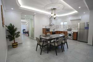 a kitchen and dining room with a table and chairs at بيت العز in Jeddah