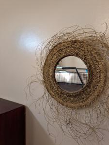 a mirror hanging on a wall with a wreath at taghazout life Guest House in Taghazout