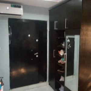 a kitchen with black cabinets and a glass door at Muniz Apartments in Lagos