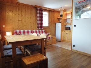 a kitchen and dining room with a table and chairs at Résidence Asphodeles in Méribel