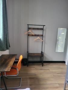 a room with a table and a chair and a mirror at Rooms4Rest Bokserska - Private rooms for tourists - ATR Consulting Sp, z o,o, in Warsaw