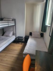 a room with two bunk beds and a table at Rooms4Rest Bokserska - Private rooms for tourists - ATR Consulting Sp, z o,o, in Warsaw