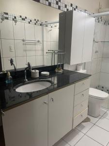 a bathroom with a sink and a toilet at Apartamento PIPA - UF01 in Pipa +35 photos