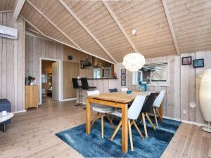 a dining room with a wooden table and chairs at Holiday home Ebeltoft CXXXVI in Ebeltoft
