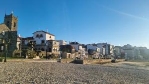 a street in a city with houses and a church at BOUZAMAR in Vigo