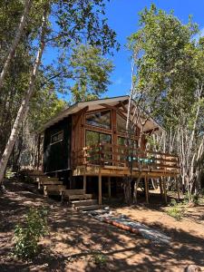 a wooden cabin in the middle of a forest at Tres Bosques in Pucón