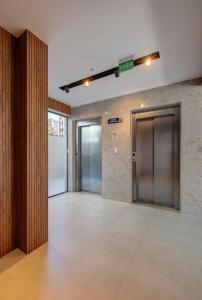 an empty lobby with elevators in a building at Apartamento 1/4 in Salvador