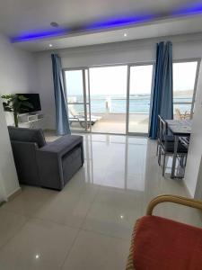 a living room with a couch and a table at Sea View Big Lanche in Praia Baixo