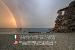 a double rainbow on a beach with the ocean at I Tibei Guesthouse Affittacamere in Monterosso al Mare
