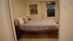 a bedroom with a bed and a window at Coolamon on Marsh in Armidale