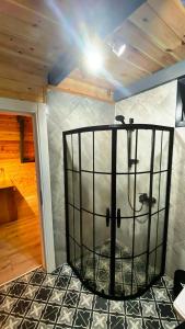a room with a shower in the middle of a room at Zua Bungalow in Pazar