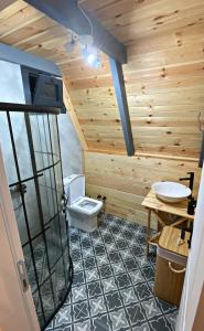 a bathroom with a toilet and a sink at Zua Bungalow in Pazar