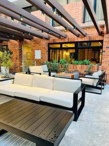 a couch sitting on a patio in a building at Miradolo 2BR Zona 10 Luxury Suite - Pool, Gym & View in Guatemala