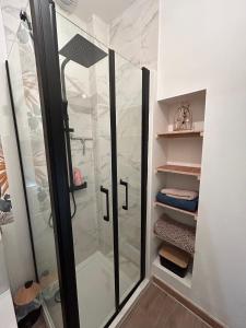 a shower with a glass door in a bathroom at Au 15 Bis - Studio Hyper Centre in Saint-Amand-Montrond