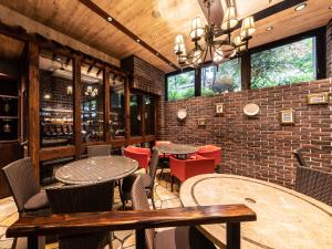 a restaurant with tables and chairs and a brick wall at APA Hotel Kyoto Eki Horikawadori in Kyoto