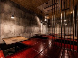 a room with two tables and a wall with windows at APA Hotel Kyoto Eki Horikawadori in Kyoto