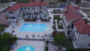 an aerial view of a house with a swimming pool at Pansion Skelin in Drinovci