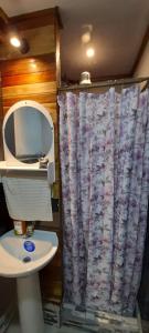 a bathroom with a toilet and a shower curtain at Casa Tauchin in Puerto Viejo