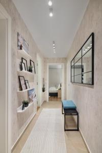 a hallway with a table and a room with a bed at Melody Apartment in Novi Beograd