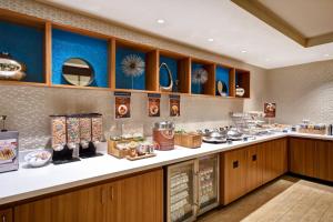 a kitchen with a counter with food on it at SpringHill Suites by Marriott Baltimore BWI Airport in Linthicum Heights