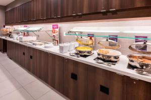 uma linha de buffet com muitas panelas e frigideiras de comida em SpringHill Suites by Marriott Fishkill em Fishkill