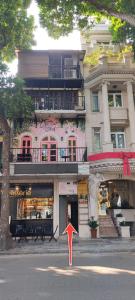 a building with a red arrow in front of it at T Home Balcony in Hanoi